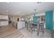 Modern kitchen with island, stainless steel appliances, and dining area at 20032 N Pine Springs Dr, Sun City, AZ 85373