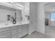 Bathroom with double vanity and a view into a bedroom at 20190 N Wilford Ave, Maricopa, AZ 85138