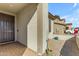 Front entryway with dark brown door and brick pavers at 20190 N Wilford Ave, Maricopa, AZ 85138