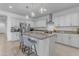 Modern kitchen with white cabinets, granite counters, and stainless steel appliances at 20190 N Wilford Ave, Maricopa, AZ 85138