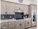 Kitchen with stainless steel appliances and dark blue backsplash at 34830 N Desert Winds Cir, Carefree, AZ 85377