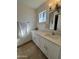 Updated bathroom with white vanity, quartz countertops, and tiled floor at 4643 W Laurel Ln, Glendale, AZ 85304