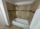 Bathroom with shower/tub, tile surround, and shelf at 4643 W Laurel Ln, Glendale, AZ 85304