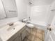 Clean bathroom with a shower/tub combo and white vanity at 521 E Cheyenne Rd, San Tan Valley, AZ 85143