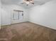 Carpeted bedroom with ceiling fan and ample closet space at 521 E Cheyenne Rd, San Tan Valley, AZ 85143