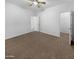 Bright bedroom with ceiling fan and access to bathroom at 521 E Cheyenne Rd, San Tan Valley, AZ 85143