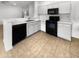 Kitchen with white cabinets, black appliances, and tile floors at 521 E Cheyenne Rd, San Tan Valley, AZ 85143