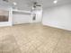 Spacious living room featuring tile floors and a ceiling fan at 521 E Cheyenne Rd, San Tan Valley, AZ 85143