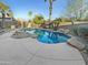 Inviting kidney-shaped pool with surrounding stone landscaping at 521 E Cheyenne Rd, San Tan Valley, AZ 85143