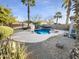 Relaxing backyard oasis featuring a sparkling pool and desert landscaping at 521 E Cheyenne Rd, San Tan Valley, AZ 85143