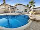 Inviting kidney shaped pool with rock landscaping at 521 E Cheyenne Rd, San Tan Valley, AZ 85143