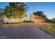 Luxury home with a grand driveway and nighttime exterior lighting at 5301 E Roadrunner Rd, Paradise Valley, AZ 85253