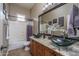 Bathroom with double vanity, glass sinks, and granite countertop at 8564 W Northview Ave, Glendale, AZ 85305