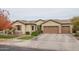 Single-story home with a three-car garage and mature landscaping at 8564 W Northview Ave, Glendale, AZ 85305