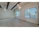 Living room with hardwood floors, wood beams, and large windows at 9526 W Cedar Hill Cir, Sun City, AZ 85351