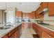 Spacious kitchen featuring granite countertops and ample wood cabinetry at 18387 W Verbena Dr, Goodyear, AZ 85338