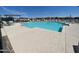 Community pool with lounge chairs and patio tables at 2624 E Dutchmans Trl, Apache Junction, AZ 85119