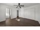 Bedroom with wood floors, double door closet and ceiling fan at 44824 N 10Th St, New River, AZ 85087