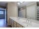 Bathroom with double vanity and a glass block shower at 7777 E 2Nd St # 111, Scottsdale, AZ 85251