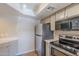 Stainless steel appliances and light wood cabinets in this kitchen at 7777 E 2Nd St # 111, Scottsdale, AZ 85251
