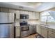 Modern kitchen with stainless steel appliances and light wood cabinets at 7777 E 2Nd St # 111, Scottsdale, AZ 85251