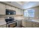 Modern kitchen with stainless steel appliances and light wood cabinets at 7777 E 2Nd St # 111, Scottsdale, AZ 85251