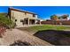 House backyard with grassy lawn and gravel at 7951 W Rushmore Way, Florence, AZ 85132