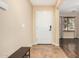 Entryway with tiled floor, bench, and door leading to the interior at 7951 W Rushmore Way, Florence, AZ 85132