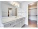 Bathroom with vanity, large mirror, and access to closet at 14300 W Bell Rd # 65, Surprise, AZ 85374
