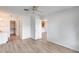 Spacious bedroom with wood-look floors and access to bathroom and closet at 14300 W Bell Rd # 65, Surprise, AZ 85374