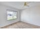 Bright bedroom with ceiling fan and wood-look floors at 14300 W Bell Rd # 65, Surprise, AZ 85374
