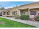 Tan stucco condo building with walkway, landscaping, and covered patio at 14300 W Bell Rd # 65, Surprise, AZ 85374