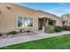 Light brown stucco condo with a covered entryway and landscaping at 14300 W Bell Rd # 65, Surprise, AZ 85374