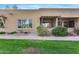 Tan colored condo with a covered patio and grassy area at 14300 W Bell Rd # 65, Surprise, AZ 85374