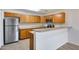 Kitchen with breakfast bar, stainless steel appliances, and view of living room at 14300 W Bell Rd # 65, Surprise, AZ 85374