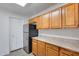 Kitchen with wood cabinets, stainless steel appliances, and pantry at 14300 W Bell Rd # 65, Surprise, AZ 85374