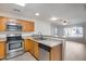 Kitchen with wood cabinets and stainless steel appliances at 14300 W Bell Rd # 65, Surprise, AZ 85374