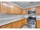 Kitchen with stainless steel appliances and wood cabinets at 14300 W Bell Rd # 65, Surprise, AZ 85374