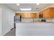 Efficient kitchen features wood cabinets, stainless steel appliances, and a breakfast bar at 14300 W Bell Rd # 65, Surprise, AZ 85374