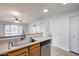 Kitchen with sink, dishwasher, and view into bathroom and hallway at 14300 W Bell Rd # 65, Surprise, AZ 85374