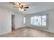 Bright living room with laminate floors, window, and door to hallway at 14300 W Bell Rd # 65, Surprise, AZ 85374