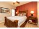 Guest bedroom with wooden bed frame and accent wall at 33550 N Dove Lakes Dr # 2026, Cave Creek, AZ 85331