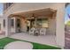 Covered patio with comfortable seating overlooking the grassy backyard at 3829 S Harlan --, Mesa, AZ 85212