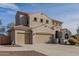 Two-story house with beige exterior, three-car garage, and landscaped front yard at 3829 S Harlan --, Mesa, AZ 85212