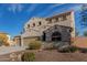 Two-story house with beige exterior, three-car garage, and landscaped front yard at 3829 S Harlan --, Mesa, AZ 85212