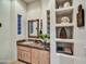 Bathroom with built-in shelves and a corner sink at 10295 E Rising Sun Dr, Scottsdale, AZ 85262