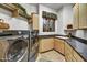 Bright laundry room, featuring modern washer and dryer, ample cabinetry, and a granite countertop at 10295 E Rising Sun Dr, Scottsdale, AZ 85262