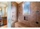 Shower with built-in seat and neutral-toned tile at 10432 E Winter Sun Dr, Scottsdale, AZ 85262