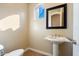 Powder room with pedestal sink and mirror at 10432 E Winter Sun Dr, Scottsdale, AZ 85262
