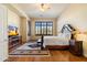 Bright and airy main bedroom with hardwood floors and large windows at 10432 E Winter Sun Dr, Scottsdale, AZ 85262